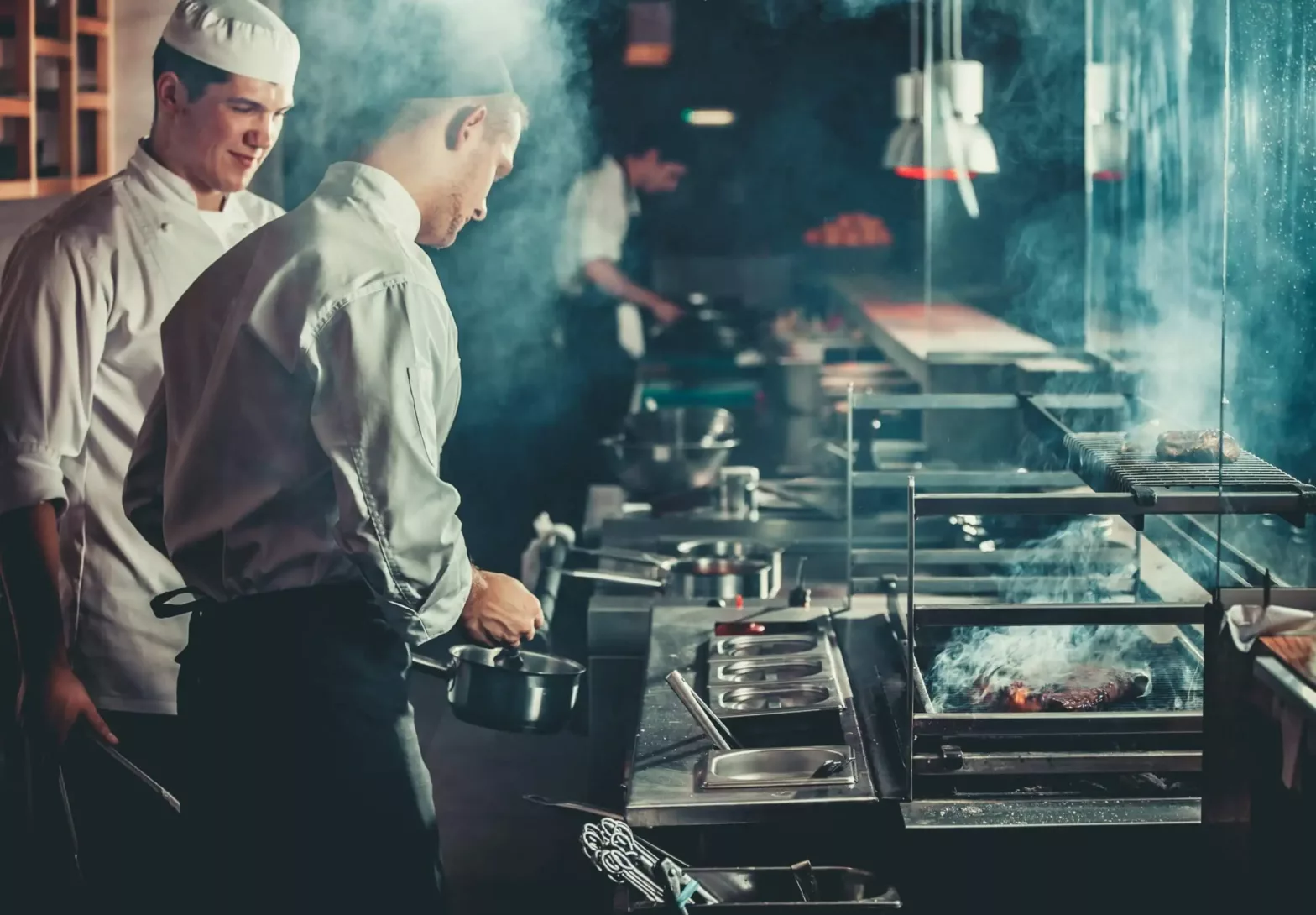 Chefs preparing meals in the kitchen