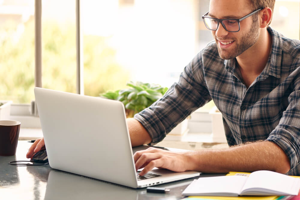 man wearing glasses taking online classes