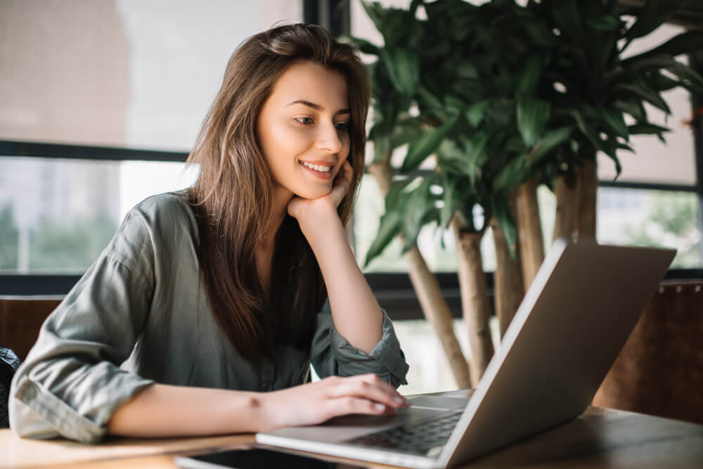 smiling woman using laptop