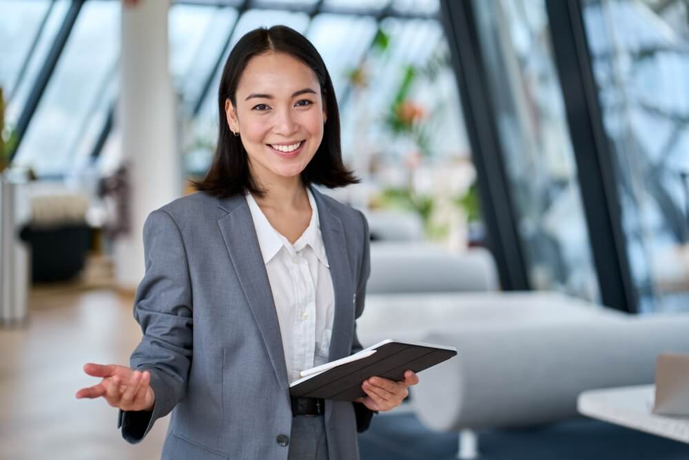 happy, young female professional holding clipboard