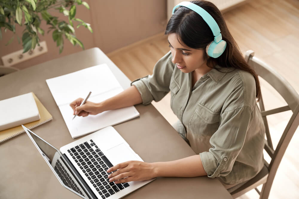 Young woman utilising modern learning tools for online business courses