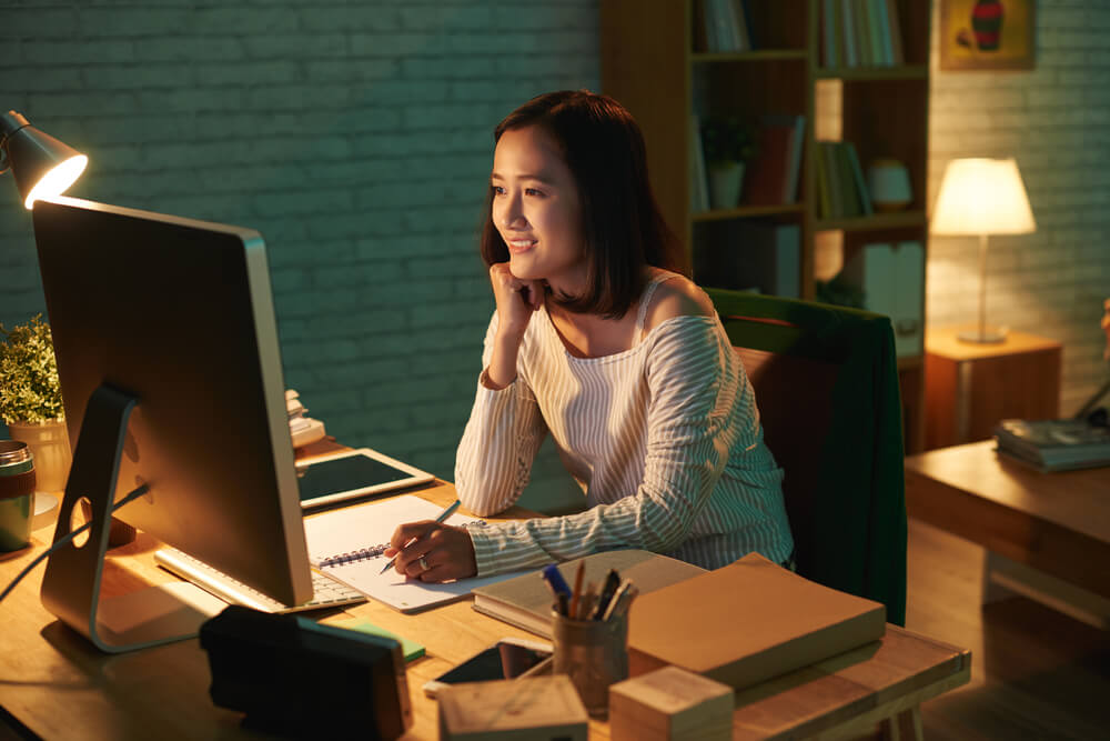 Asian student taking online courses at night