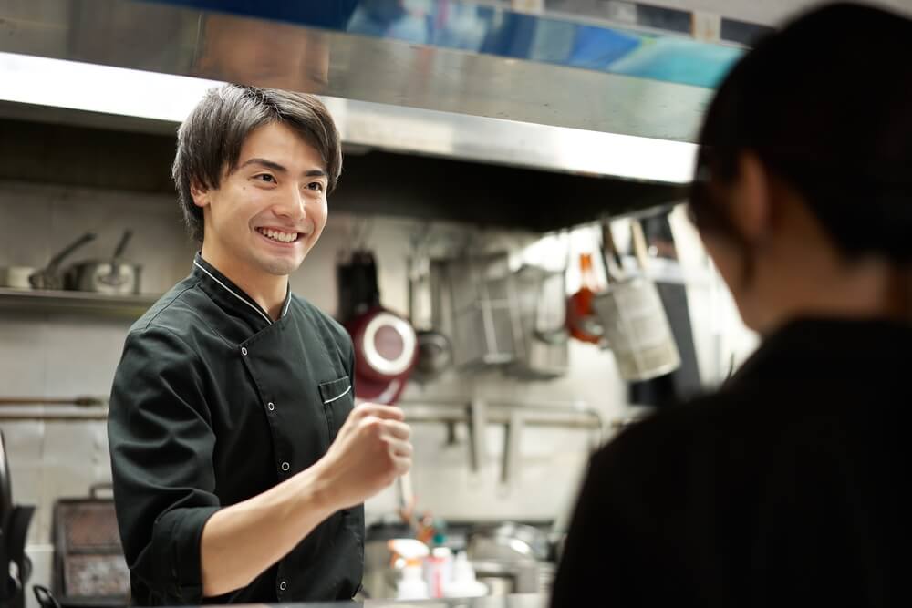 A senior staff member encouraging a hospitality student at work