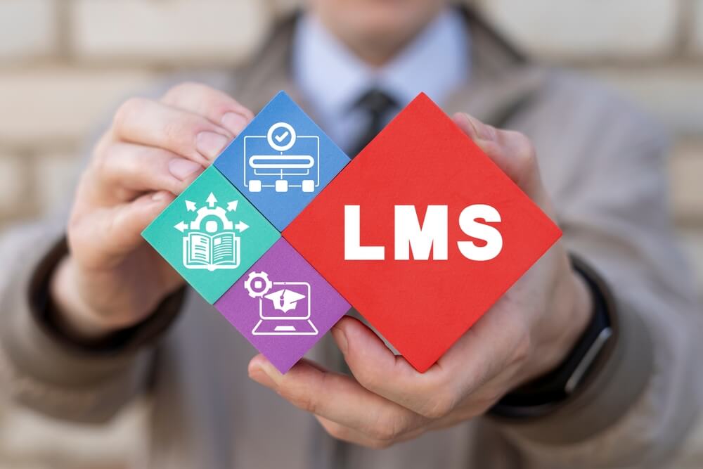 man holding blocks with LMS letters and icons